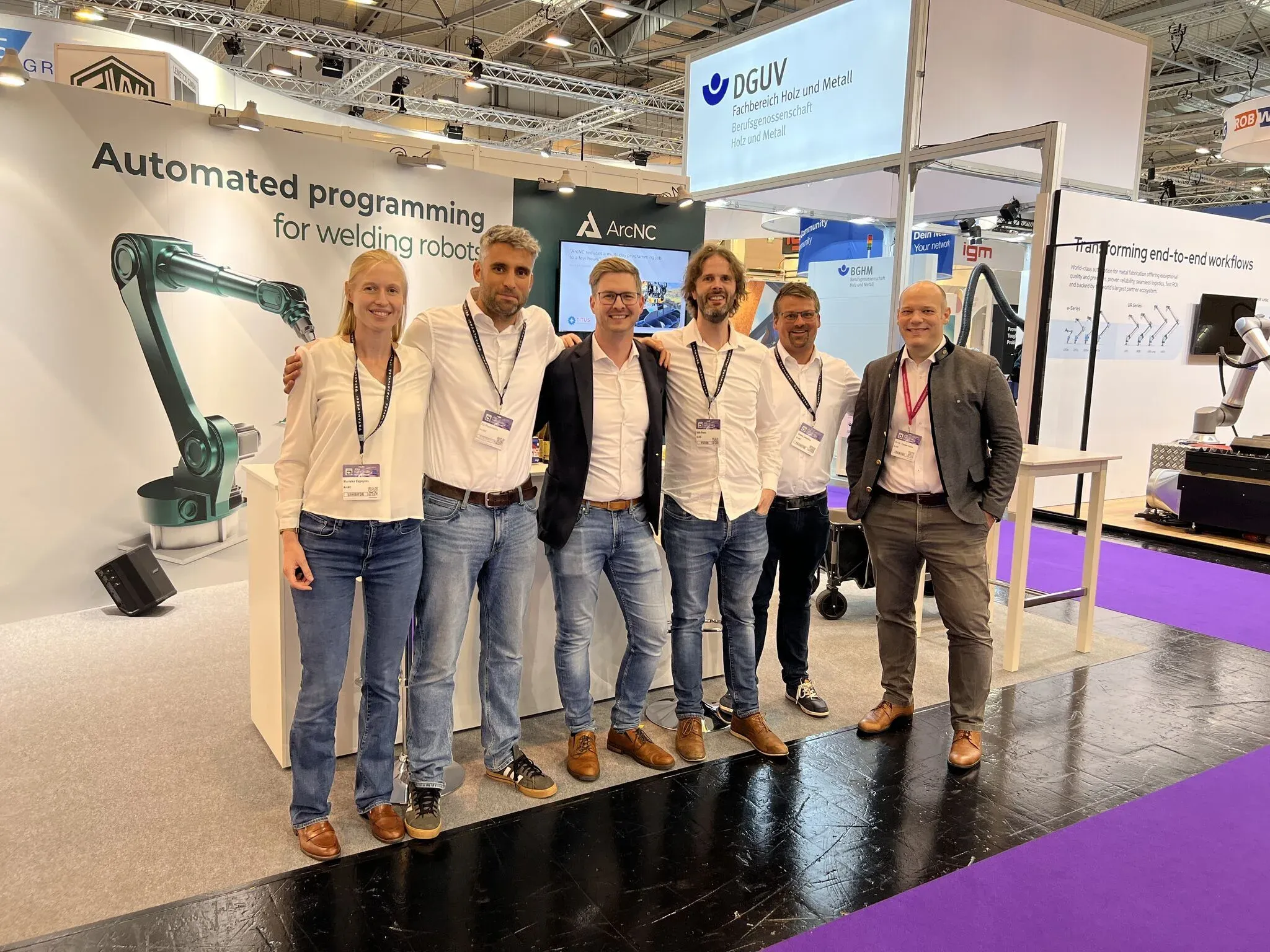 Six people standing together at an ArcNC exhibition stand